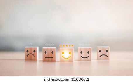 customer services best excellent business rating experience. Satisfaction survey concept. Hand of a businessman chooses a smiley face on wood block cube. 5 Star Satisfaction