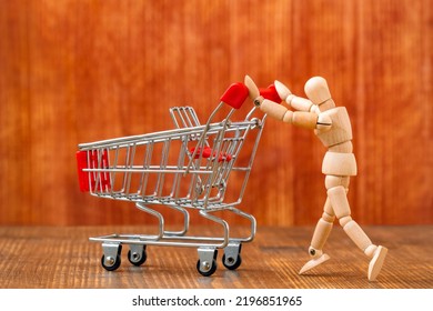 Customer With Shopping Cart. Let's Go Shopping! Wooden Dummy Pushing An Empty Shopping Cart. 