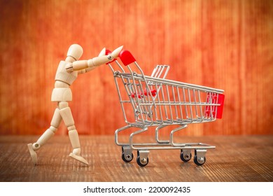 Customer With Shopping Cart. Let's Go Shopping! Wooden Mannequin Pushing An Empty Shopping Cart. 