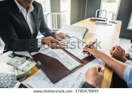Customer signing contract documents for realty purchase, Bank employees congratulate, Concept mortgage loan approval. Business loan from a bank employee. finance concept .