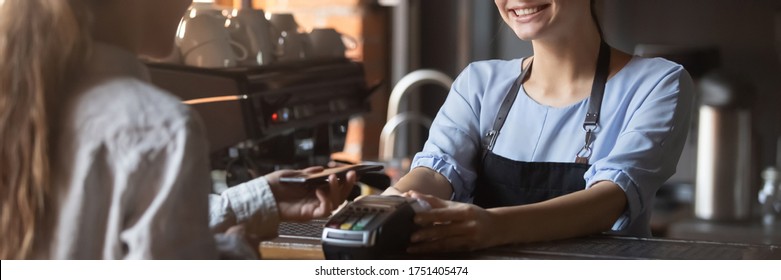 Customer stand near bar counter pay bill using cell application and pos machine. Mobile payment apps advertisement, smartphone is your wallet concept. Horizontal photo banner for website header design - Powered by Shutterstock