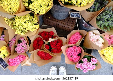 A customer standing in front of the florist shop and decide to get some roses for Valentine's Day - Powered by Shutterstock