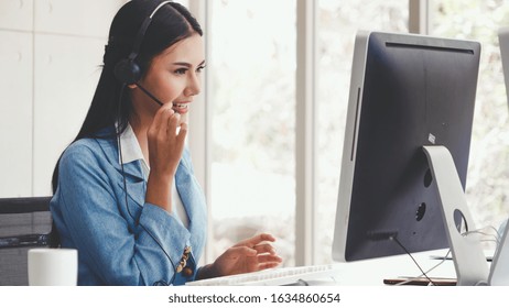 Customer Support Agent Or Call Center With Headset Works On Desktop Computer While Supporting The Customer On Phone Call. The Operator Service Agent Represents Omnichannel Concept.