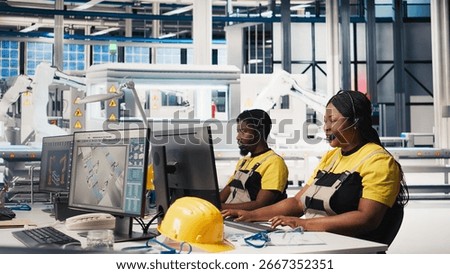Customer support black engineer at help desk in photovoltaic facility answering calls on headset, offering assistance and support in fixing technical issues. Female operator on help line. Camera B.