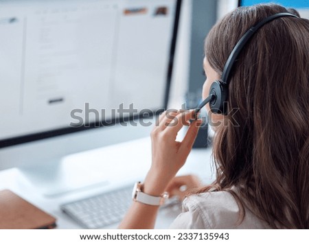 Customer support, call center and back of female agent working on online consultation in the office. Telemarketing, communication and saleswoman planning crm with headset and computer in workplace.
