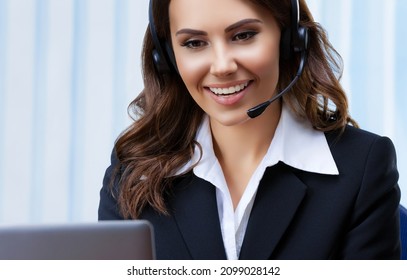 Customer Support Female Phone Operator Or Sales Agent In Headset And Black Suit, Working With Laptop At Office Workplace. Consulting Help And Assistance Service Call Center Skype Zoom Video Conference