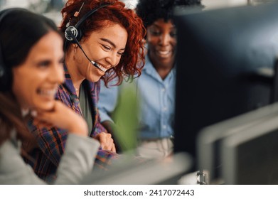 A customer support operator is sitting at call center in the office and contacting client. A woman is having headset and talking to a client online. A friendly operator is solving technical problems. - Powered by Shutterstock