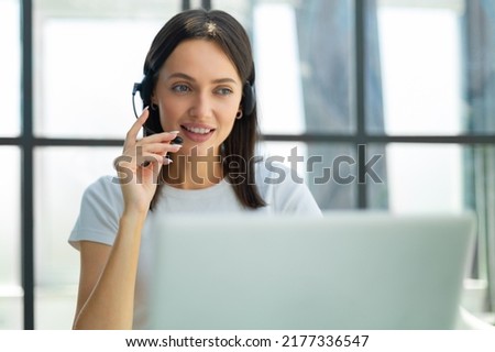 Customer support operator working in a call center office.