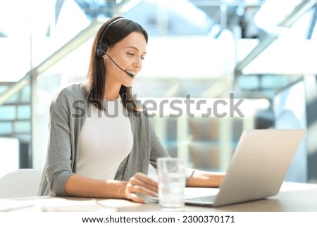 Customer support operator working in a call center office