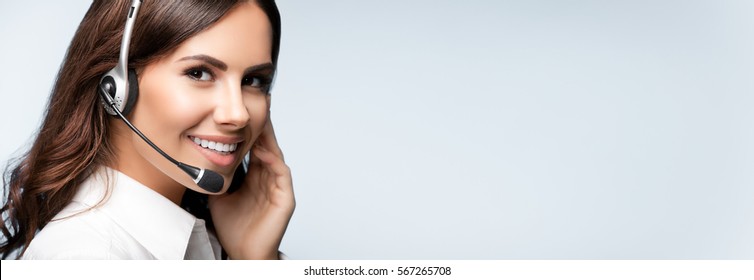 Customer Support Phone Operator In Headset, With Blank Copyspace Area For Slogan Or Text Message, Over Grey Background. Consulting And Assistance Service Call Center.