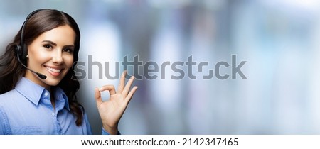 Customer support phone operator in headset showing ok okay or zero hand sign gesture, on blurred office interior background. Consulting and assistance service call center. Business woman. Callcenter.