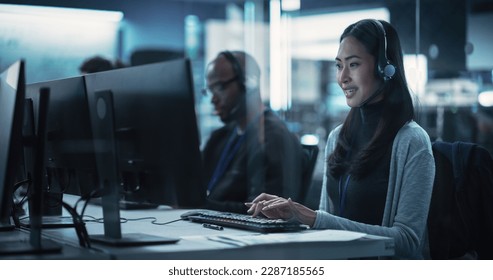 Customer Support Professional Using Computer and Talking with Client on a Call. Asian Help Desk Employee Responds to Queries, Resolve Problems and Troubleshoot Issues, Implement Solutions - Powered by Shutterstock - Get 15% off with code: PIKWIZARD15