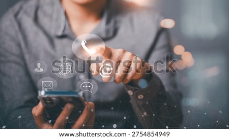 Customer support representative using smartphone ,pressing virtual contact icons for phone, email and chat, representing mobile communication, digital service, CRM strategy ,online customer engagement