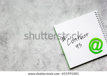 customer support service desktop with contact us signs on gray background top view mock-up