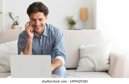 Customer Support. Smiling Man Using Laptop Talking On Phone With Call Center Operator At Home. Free Space