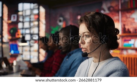 Customer support workers listening to clients problems using headphones. Call center agents in office using headset microphone to provide information, solving customers concerns, camera B close up