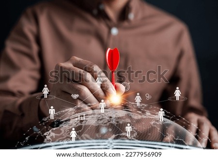 Customer Targeting the business concept, Businessman aiming red arrow dart to the target dartboard, Executive marketing, investment goal and target for planning development customer target group.