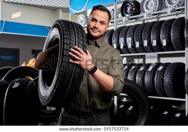 customer\
tire fitting in the car service, auto mechanic checks the tire and\
rubber tread for safety, concept: repair of machines, fault\
diagnosis, repair. man buy in car service\
shop