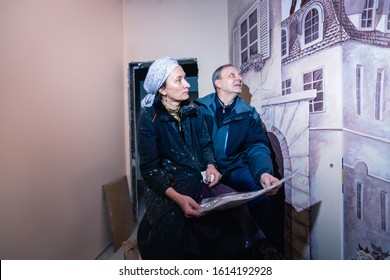 The Customer, Together With The Artist, Is Considering Painting The Walls In The Room. Mural Inspired By The Memories Of Paris. Man And Woman Look At The Image On The Wall