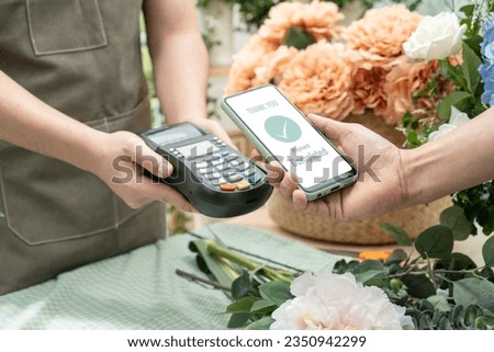 Customer using phone for payment at cafe restaurant,cashless technology and money transfer concept.Customer using smartphone for NFC payment