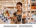 Customer using smartphone to buy cosmetics