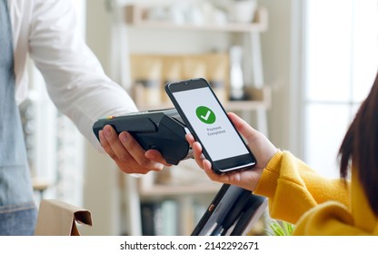 Customer using smartphone for NFC payment at cafe restaurant, cashless, contactless technology and money transfer concept - Powered by Shutterstock