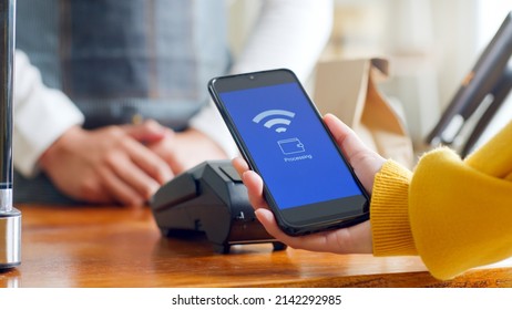 Customer Using Smartphone For NFC Payment At Cafe Restaurant, Cashless, Contactless Technology And Money Transfer Concept