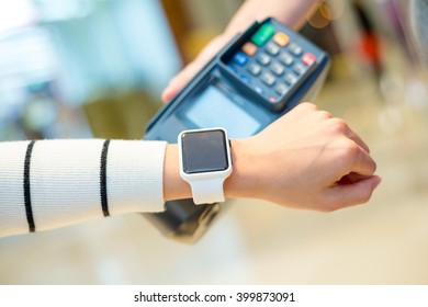 Customer Using Smartwatch To Pay The Bill