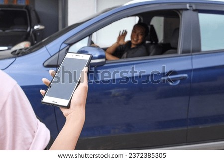 Customer waiting driver to pick up on city street. Mobile and online booking for rideshare transportation with cellphone.