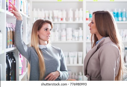 Customer Woman Choosing Cosmetics With Assistant At Beauty Store