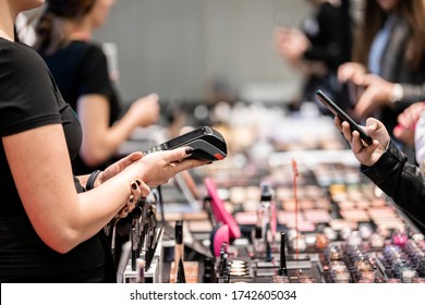 Customer Woman Paying For A Products Using Smartphone In Beauty Store