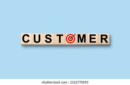 Customer wording on wooden cube block with red target board with arrow drawing for business customer focus and target concept. Putting wooden cubes with focused on target customer symbols. - Shutterstock ID 2152770593