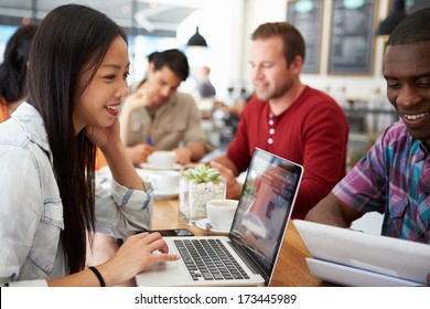 Customers In Busy Coffee Shop