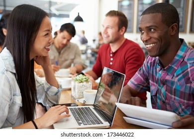 Customers In Busy Coffee Shop