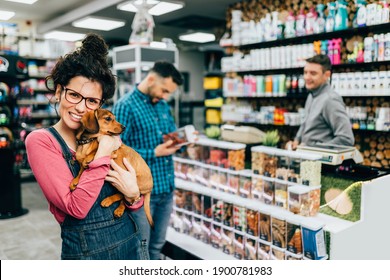 Customers Buying Accessories And Food For Their Pet In Pet Shop.