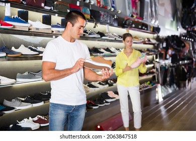 Customers Choosing Sneakers In Streetwear Store