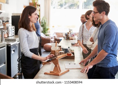 Customers At A Coffee Shop Queuing To Order And Pay