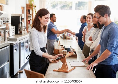 Customers Queuing To Order And Pay At A Coffee Shop Counter