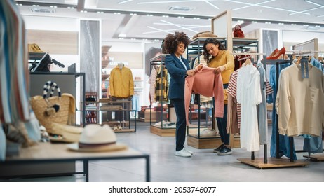 Customers Shopping in Modern Clothing Store, Retail Sales Associate Assists Client. Diverse People in Fashionable Shop, Choosing Stylish Clothes, Colorful Brand Designs, Quality Sustainable Materials. - Shutterstock ID 2053746077