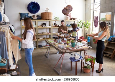 Customers And Staff In A Busy Clothes Shop