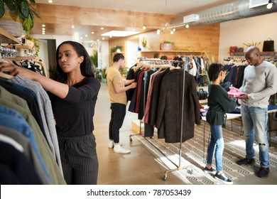 Customers And Staff In A Busy Clothes Shop