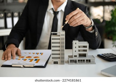 Customers who choose to buy a condominium room and a bank approve a loan for their purchase. Condominium and house loan interest rate from bank concept at office