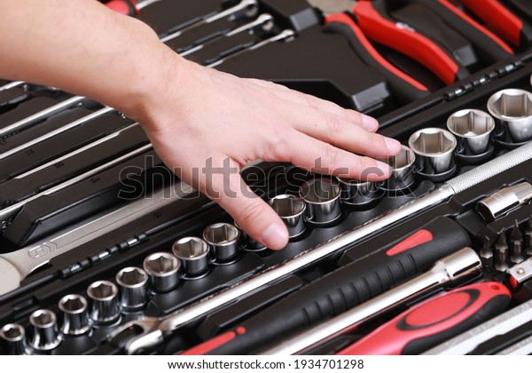 Customers or worker, builder,\
repairman, handyman, at the store chooses wrench, nuts, instrument,\
tools. Display of tools shop marketing for home and auto\
repair.