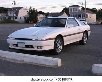 A Customized White Sports Car Parked At The Beach.