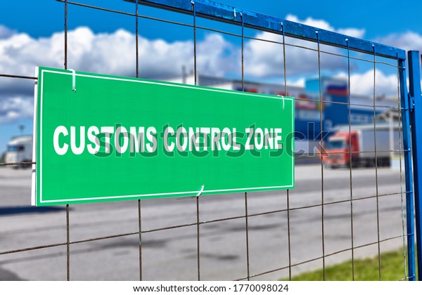 Customs\
clearance sign on the territory of the logistics customs terminal,\
with temporary storage of goods at the bonded warehouse. Trucks\
stand near the unloading and loading\
area.