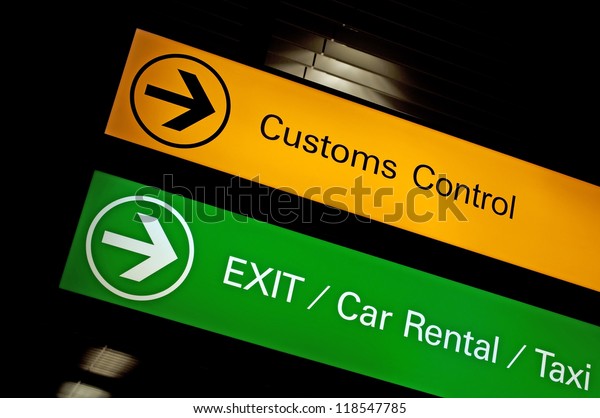 Customs control, exit, car rental and taxi sign\
at international\
airport.