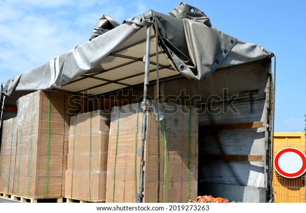 customs control of a\
van or truck. the car\'s tarpaulins are raised and suspicious cargo\
boxes are visible on the pallet. Search for refugees in the body of\
the truck.