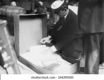 Customs Officer Inspecting Luggage Of A Passenger At The Norddeutscher Lloyd Pier In New York City. Ca. 1909