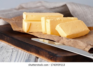 Cut butter on plate with blue towel on kitchen table - Powered by Shutterstock