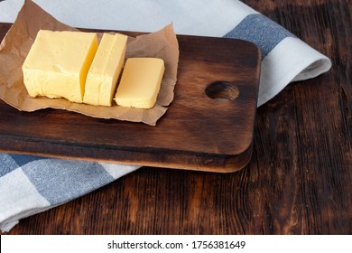 Cut butter on plate with blue towel on kitchen table - Powered by Shutterstock